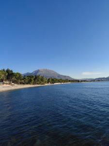 a large body of water with mountains in the background at Apartment Maruni in Šušanj