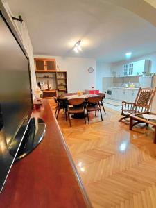 a living room with a table and a dining room at Apartment Maruni in Šušanj +16 photos