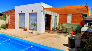 a house with a swimming pool next to a house at Casa en Concon in Vina del Mar