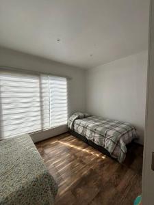 a bedroom with two beds and a window at Casa en Concon in Vina del Mar +13 photos