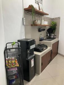 een keuken met een spoelbak, een fornuis en een plank bij Wening Stay in Srondolwetan +14 foto's