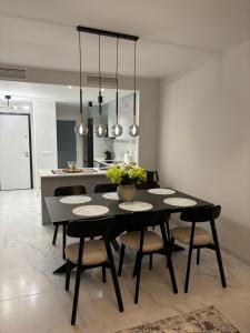 a dining room with a black table and chairs at Flamenca Village- Apartment 459 in Orihuela Costa