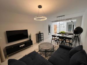 a living room with a couch and a dining room at Flamenca Village- Apartment 459 in Orihuela Costa