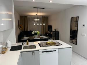 a kitchen with a sink and a living room at Flamenca Village- Apartment 459 in Orihuela Costa