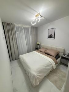 a white bedroom with a large bed and a window at Flamenca Village- Apartment 459 in Orihuela Costa +27 photos