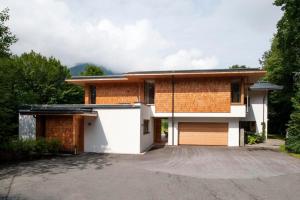 a house with a driveway and a garage at Winklern Lodges in Kitzbühel