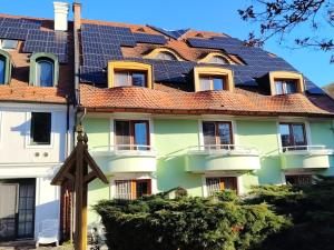 a building with solar panels on the roof at Queen Lisbeth Street in Keszthely