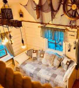 a bedroom with a bed with pillows and a window at Kaj's Cabin in Listerby