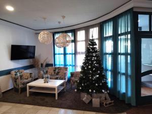 a living room with a christmas tree in it at Queen Lisbeth Street in Keszthely