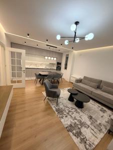 a living room with a couch and a table at LUX Apt Korca in Korçë