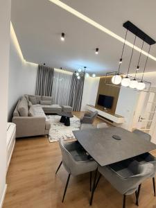 a living room with a table and a couch at LUX Apt Korca in Korçë
