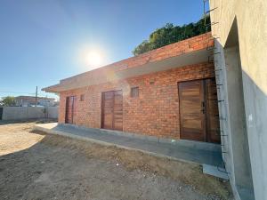 a brick building with two doors on the side at Pousada Serena Jacumã in Conde +4 photos