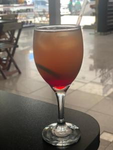 a drink in a glass sitting on a table at Hotel e Conveniência G3 in Teixeira de Freitas +5 photos