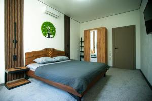 a bedroom with a bed with a wooden head board at Art-House in Uzhhorod
