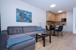 a living room with a couch and a table at Lúka Palúdzka in Liptovský Mikuláš