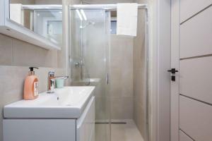 a white bathroom with a sink and a shower at Lúka Palúdzka in Liptovský Mikuláš +170 photos