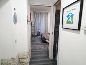 a hallway with a stairwell leading to a living room at Casa Vacanze 21 Ventuno in Antrodoco +21 photos