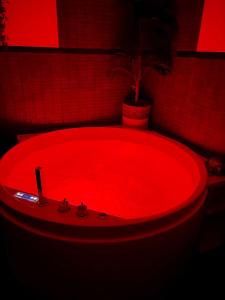 a red bath tub in a room with a plant at Chalet Barceló Rocher in Cala d´Or +92 photos
