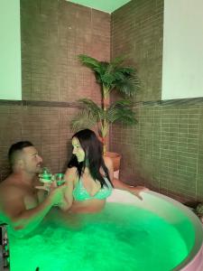 a man and a woman sitting in a bath tub at Chalet Barceló Rocher in Cala d´Or