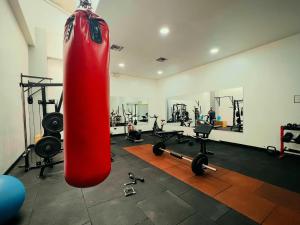 a gym with a large red punching bag in a room at Luxury City Suites in Guayaquil