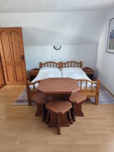 a bedroom with a wooden table and a bed at Chalúpka Paci in Ždiar +28 photos