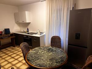 a kitchen with a table and a kitchen with a sink at Dortmund Brackel Wohnung in Dortmund