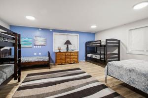 a bedroom with two bunk beds and a rug at 4-Bedroom Chateau in Southern Washington- Luxurious Retreat with Pond & Creek in Amboy