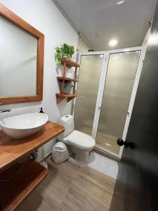 a bathroom with a sink and a toilet and a shower at Posada Kotnat in San Andrés +10 photos