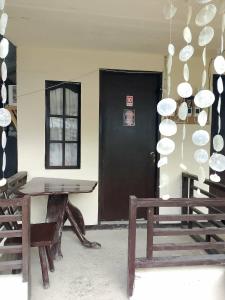 a room with a table and a black door at El Nido Cabugao Loudge in El Nido +56 photos