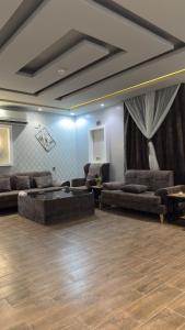 a large living room with couches and a table at شاليه ريفالا الفاخر in Abha