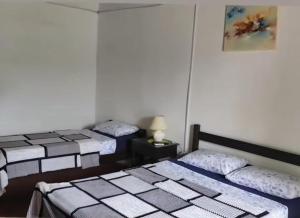 a room with three beds in a room at Ruma in Bella Unión