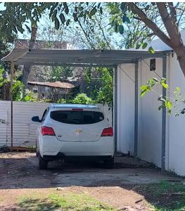 a white car is parked in a garage at Ruma in Bella Unión