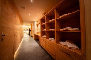 a room with wooden shelves and a hallway with towels at Hotel Garni Castel B&B in Ischgl +41 photos