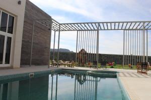 een zwembad voor een gebouw bij Masfout Mountains View in Sinādil