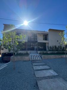 a building with the sun shining in front of it at Casa mansa hostel in Maldonado