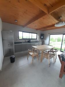 a kitchen with a table and chairs in a room at Casa Aramí in Victoria