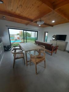 a dining room with a table and chairs and a tv at Casa Aramí in Victoria