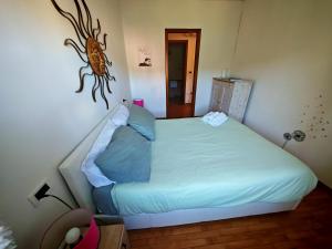 a bedroom with a bed with a fish on the wall at CASA VACANZA Emma in Monfalcone