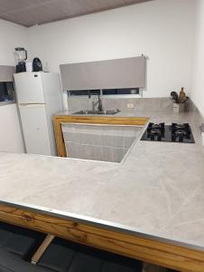 a kitchen with a sink and a counter top at Lofth house in Piriápolis +15 photos