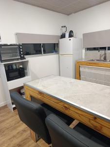 a kitchen with a marble counter top and appliances at Lofth house in Piriápolis