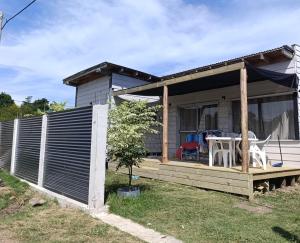 a house with a porch with a table and chairs at Lofth house in Piriápolis