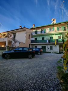 twee auto's geparkeerd voor een gebouw bij CASA VACANZA Emma in Monfalcone