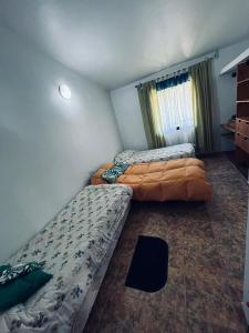 een slaapkamer met twee bedden en een raam bij Hospedaje Davolio in Yerba Buena