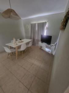 ein Wohnzimmer mit Tisch und Fernseher in der Unterkunft Lamorit in Almafuerte