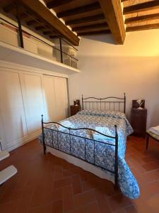 a bedroom with a bed in a room at La terrazzina nel borgo apt dimora storica toscana pool&garden in Lano +31 photos