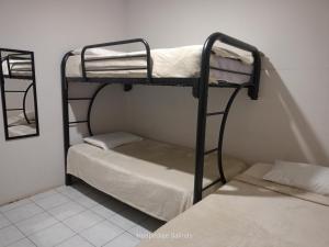two bunk beds in a room with a mirror at Riveri Salinas V53 in Salinas +26 photos
