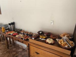 a table filled with lots of different types of food at pousada canarinho in Tiradentes +30 photos