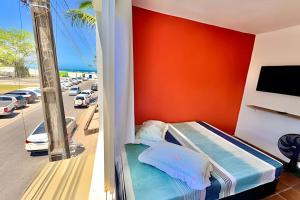 a bedroom with a bed and a view of a parking lot at BriSa Do Mar < Flecta Matinhos in Matinhos
