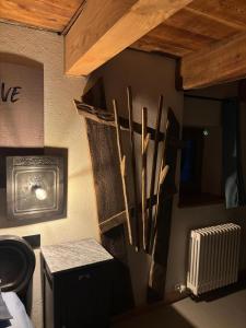 a room with a wall with some wooden art on it at Riverside Room Joseph in Pontboset