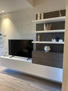 a living room with a large flat screen tv at Brezza di mare home con garage in Civitanova Marche